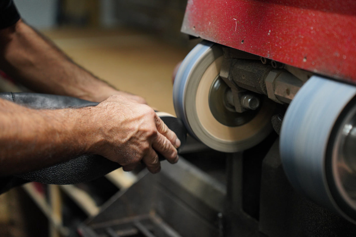 ShoeMedic cobbler repairing a shoe on a finishing machine in Oakville