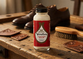 Imperial Venetian Leather Balm bottle on rustic wood with brown leather shoes and brush, for shoe care and conditioning