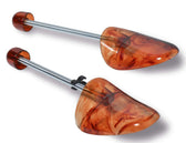 Amber marbled shoe trees with adjustable metal rods for leather shoe care and shape preservation