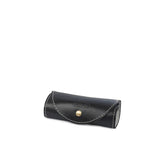 Black leather shoe care kit case with white stitching and gold snap closure