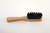 Wooden shoe brush with black bristles for leather care and polishing