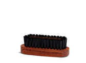 Wooden shoe brush with black and brass bristles for leather care and polishing