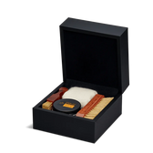 Luxury leather shoe care kit with cream, brushes, and cloth in black gift box