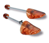 Amber marbled shoe trees with adjustable metal rods for leather shoe care and shape preservation
