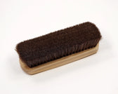 Wooden shoe brush with dense brown bristles for leather care and polishing