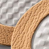 Close-up of textured tan leather shoe sole with gray patterned insole for premium leather care