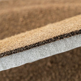 Close-up of layered shoe insole with foam cushion and textured top for comfort and support
