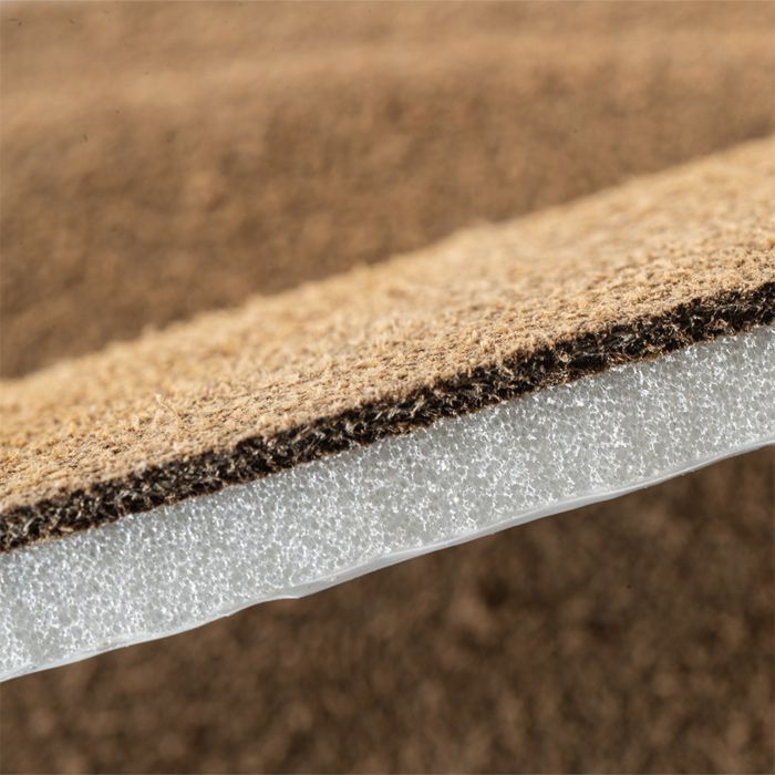 Close-up of layered shoe insole with foam cushion and textured top for comfort and support