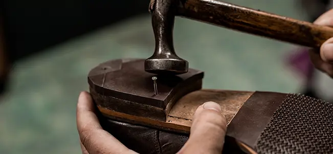 Cobbler hammering shoe sole repair